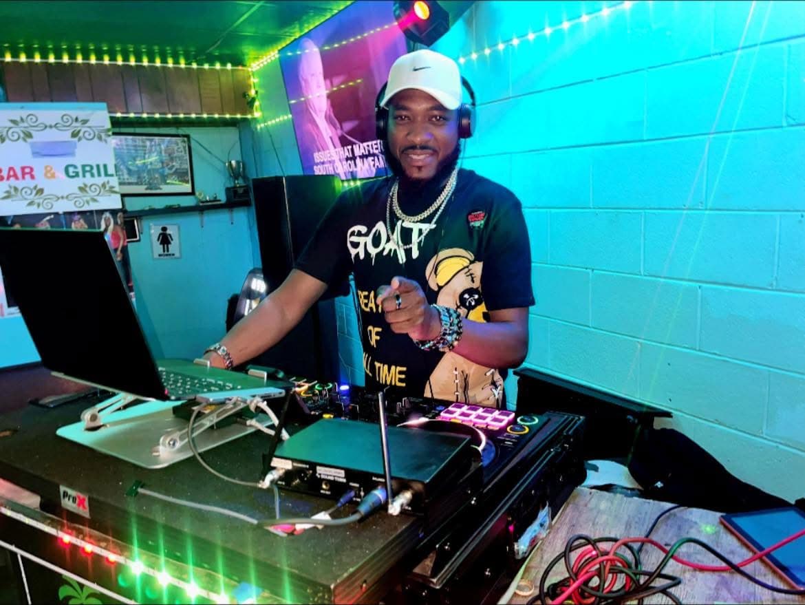 DJ Press performing live behind a premium DJ booth setup